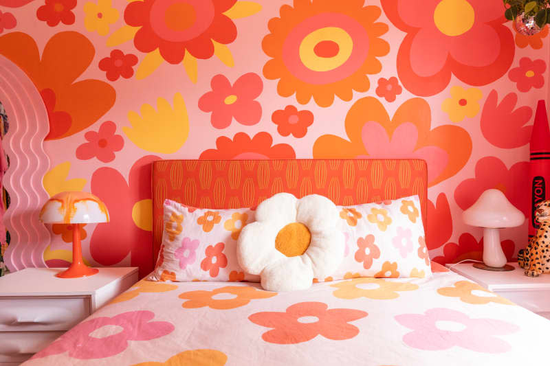 Pink and orange floral wallpaper in bedroom.
