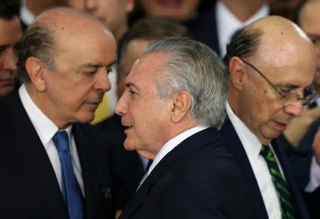 Brazil's interim President Michel Temer (C) stands near newly sworn-in Foreign Minister Jose Serra (L) and Finance Minister Henrique Meirelles, after the Brazilian Senate voted to impeach President Dilma Rousseff, at the Planalto Palace in Brasilia, Brazil, May 12, 2016. REUTERS/Adriano Machado