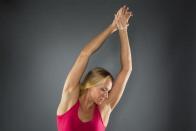 Swimmer Dana Vollmer stretches while posing for a portrait during the 2012 U.S. Olympic Team Media Summit in Dallas, May 15, 2012.