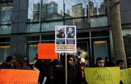 Demonstrators hold signs during a rally against the execution of Shi'ite cleric Sheikh Nimr al-Nimr in Saudi Arabia, in New York January 3, 2016.REUTERS/Shannon Stapleton