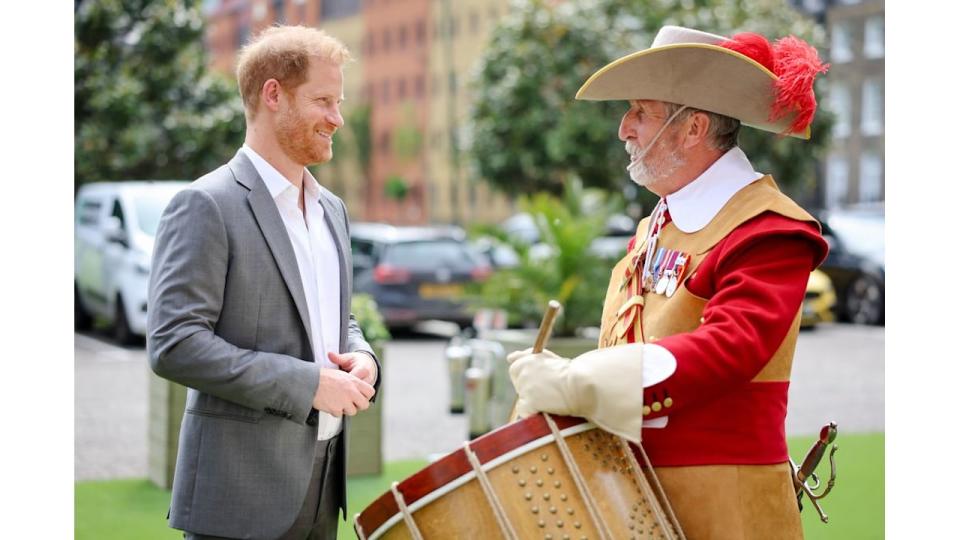 Prince Harry speaking with a drummer