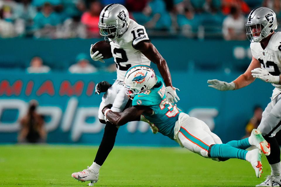 Miami Dolphins cornerback Kader Kohou tackles Las Vegas Raiders wide receiver Justin Hall. [RICH STORRY/USA TODAY Sports]