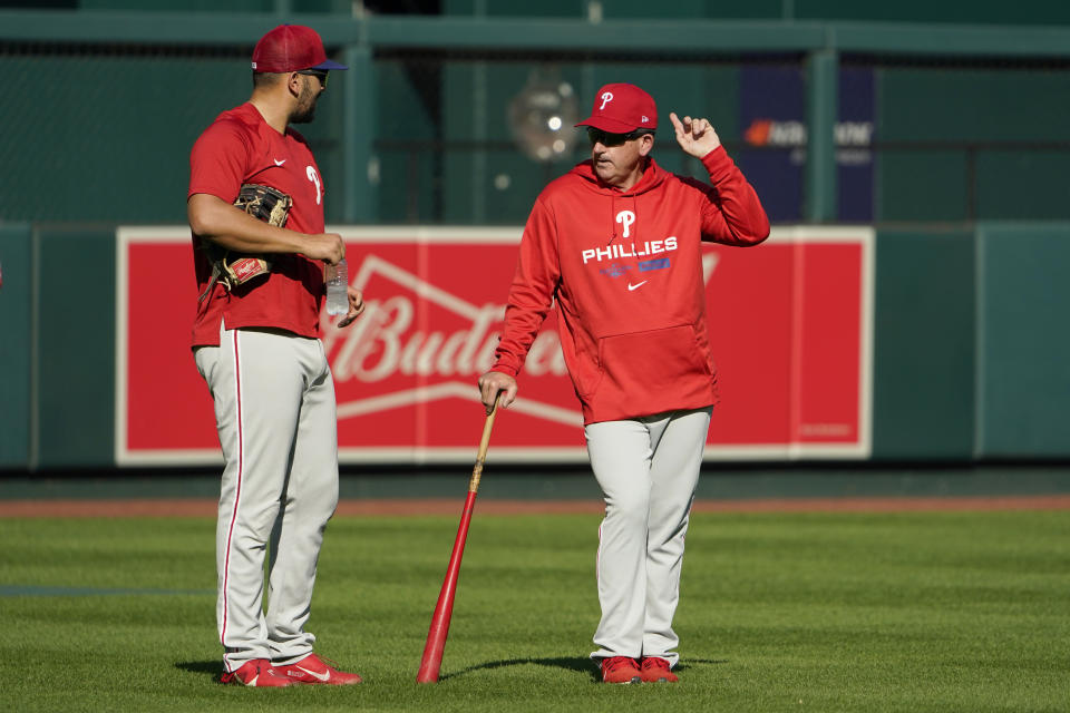 Philadelphia Phillies interim manager Rob Thomson, right, talks with Darick Hall during baseball practice Thursday, Oct. 6, 2022, in St. Louis. The Phillies and St. Louis Cardinals are set to play Game 1 of a National League Wild Card baseball playoff series on Friday in St. Louis. (AP Photo/Jeff Roberson)