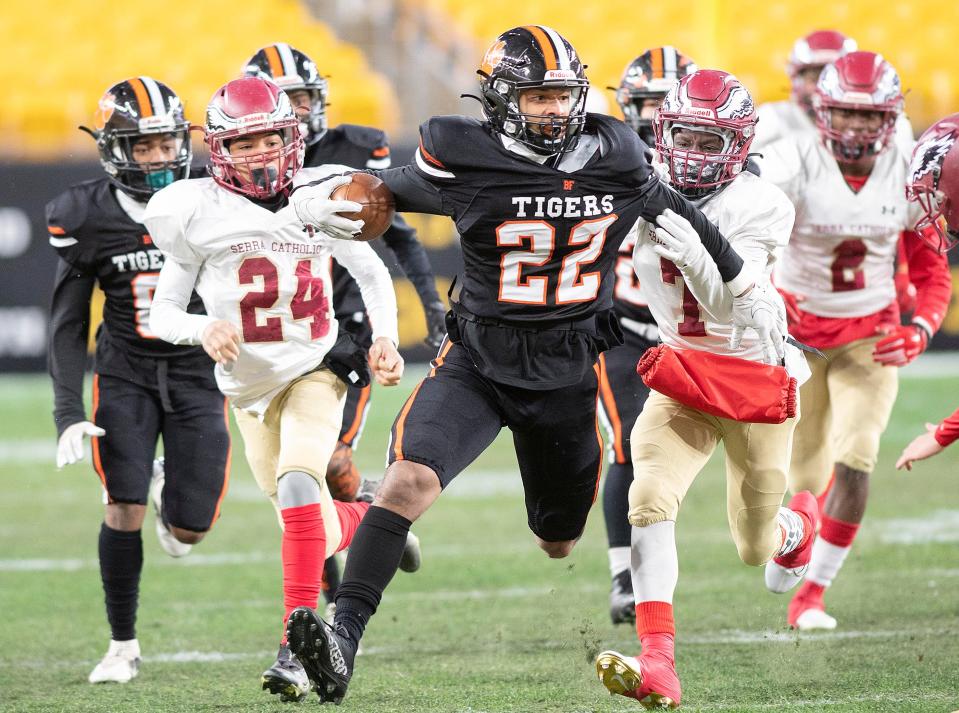 Beaver Falls' Isaiah Aeschbacher carries the ball as Serra Catholic's DaiQuan Chatfield attempts to tackle him during the WPIAL Class 2A championship game, Friday at Heinz Field.