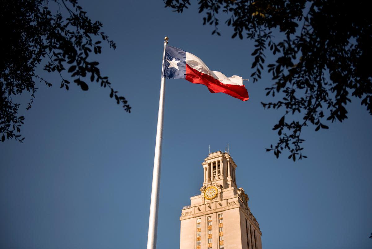 The Texas flag flies on the south lawn of The Univerisity of Texas at Austin campus on Dec. 3, 2019.