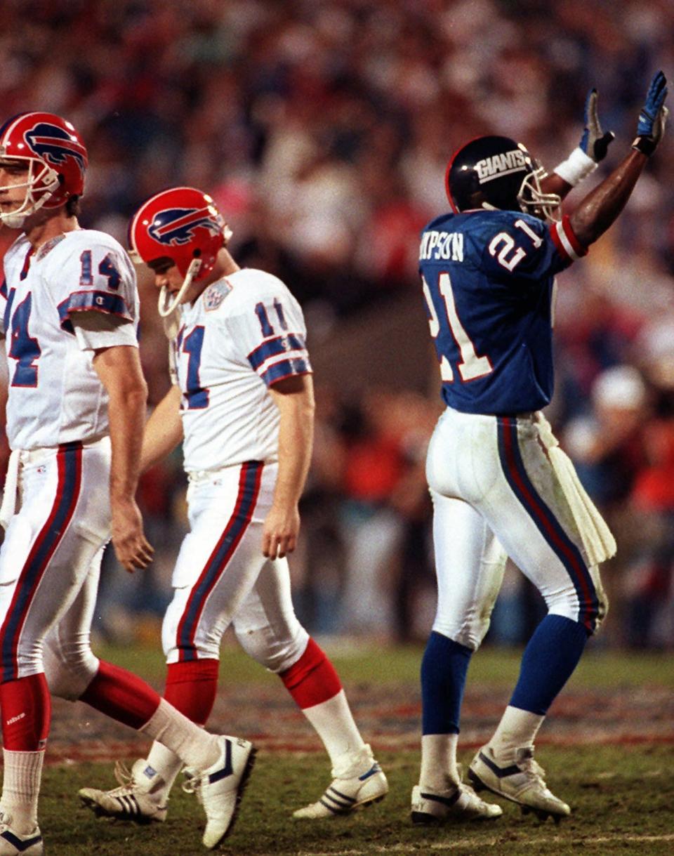 -

-FILE -- Buffalo Bills kicker Scott Norwood (11) and holder Frank Reich (14) walk off the field dejected after missing a 47-yard field goal on the last play of the game, as Giants Reyna Thompson celebrates a 20-19 victory in Super Bowl XXV in Tampa, Fla., in this Jan. 20, 1991 photo. The Giants, back at the spot where they won the Super Bowl a decade ago, begin practice for this year's championship against the Baltimore Ravens. (AP Photo/Rusty Kennedy)