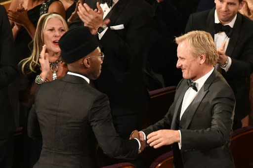 "Green Book" co-stars Mahershala Ali (L) and Viggo Mortensen shake hands after the movie won the best picture Oscar