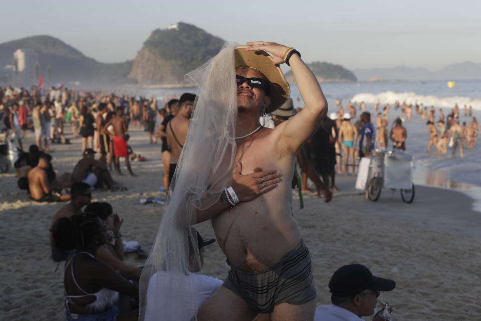 A fan strikes a pose as he waits for the start of Madonna's last show of her The Celebration Tour, on Copacabana beach in Rio de Janeiro, Brazil, Saturday, May 4, 2024. (AP Photo/Bruna Prado)