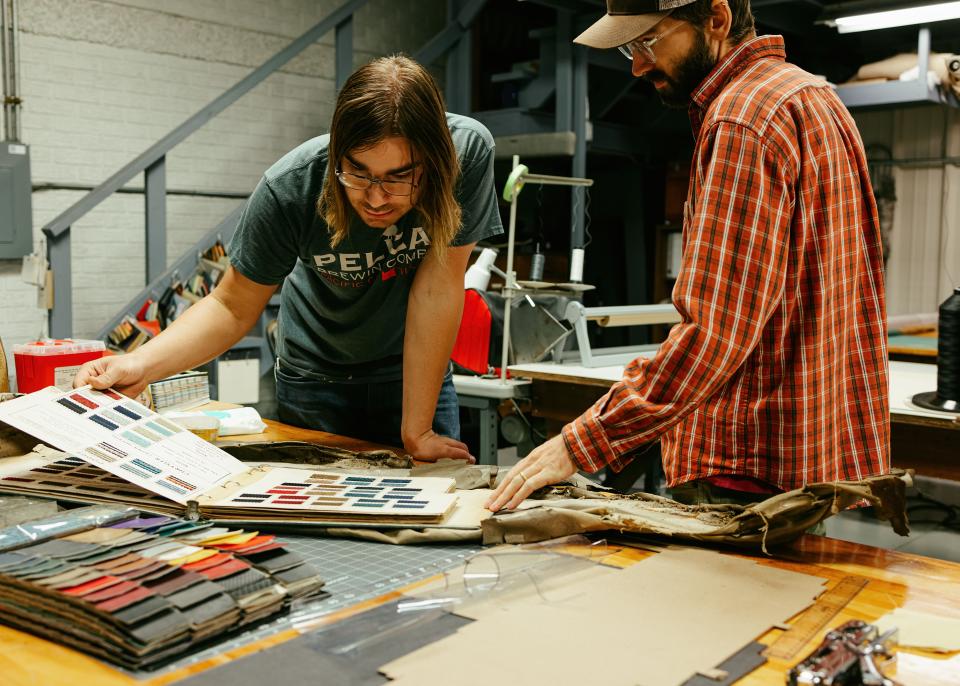 McPherson College Auto Restoration students choose materials for a seat cushion project.