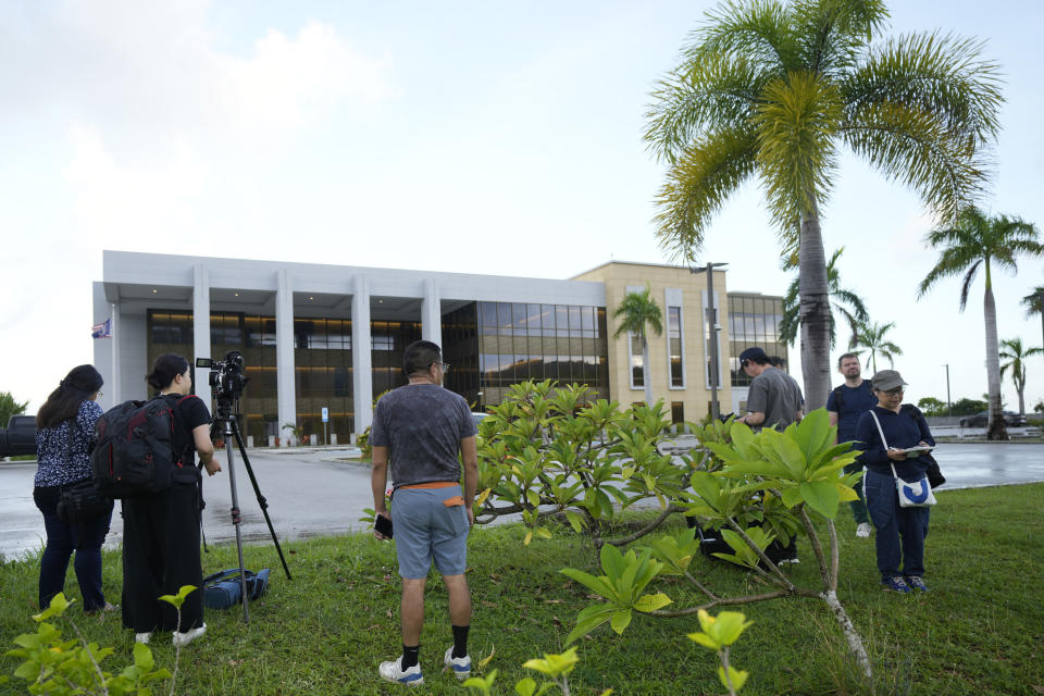 Journalists wait for WikiLeaks founder Julian Assange outside the United States courthouse where he is expected to enter a plea deal, in Saipan, Mariana Islands, Wednesday, June 26 2024. (AP Photo/Eugene Hoshiko)