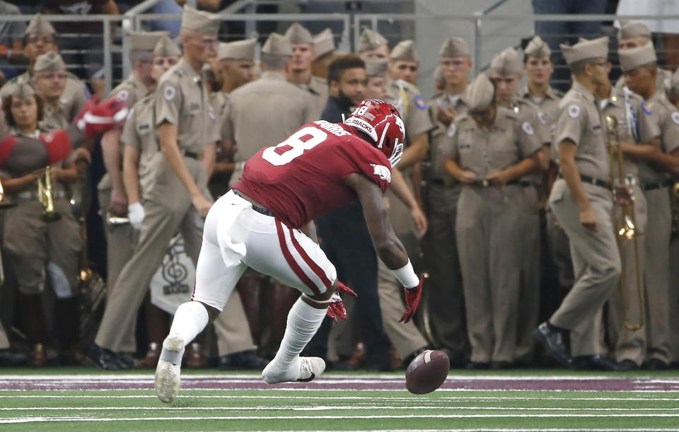 Arkansas linebacker De'Jon Harris (8) picks up a Texas A&M fumble before taking the ball into the end zone for a touchdown during the first half of an NCAA college football game Saturday, Sept. 28, 2019, in Arlington, Texas. (AP Photo/Ron Jenkins)