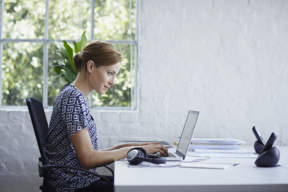 Woman working on computer replying to emails