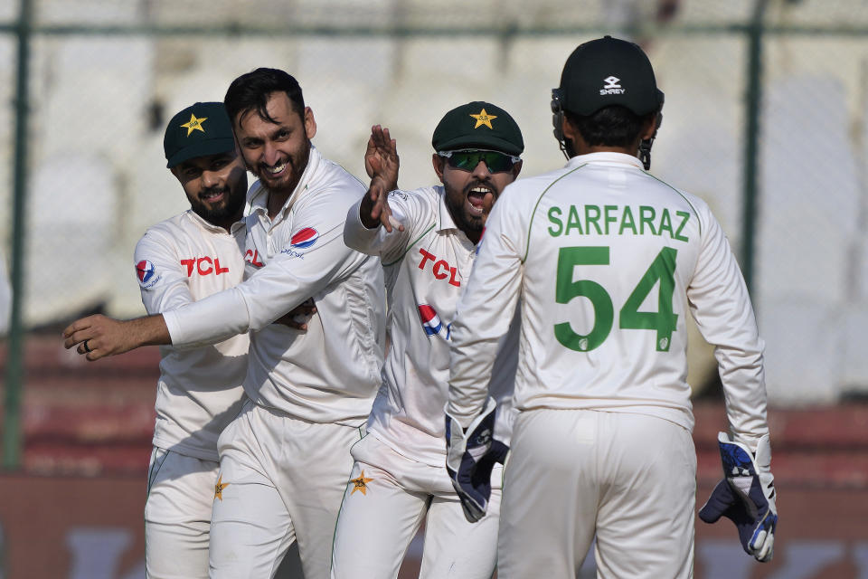 Pakistan's Agha Salman, second left, celebrates with teammates after taking the wicket of New Zealand's Devon Conway during the first day of the second test cricket match between Pakistan and New Zealand, in Karachi, Pakistan, Monday, Jan. 2, 2023. (AP Photo/Fareed Khan)