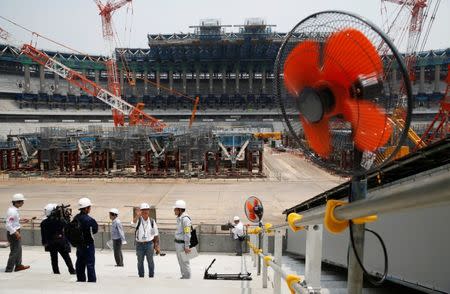 Electrical fans are seen during a heat wave, at the construction site of the New National Stadium, the main stadium of the Tokyo 2020 Olympics and Paralympics, during a media opportunity in Tokyo, Japan July 18, 2018. REUTERS/Issei Kato