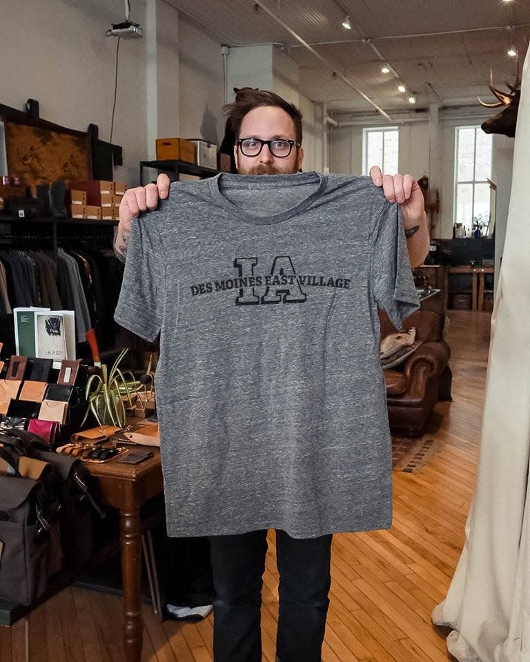 Fontenelle Supply Co. Co-Owner Erich Bockman holds a screen-printed shirt. The East Village business specializes in making handmade leather goods and screen-printed T-shirts.