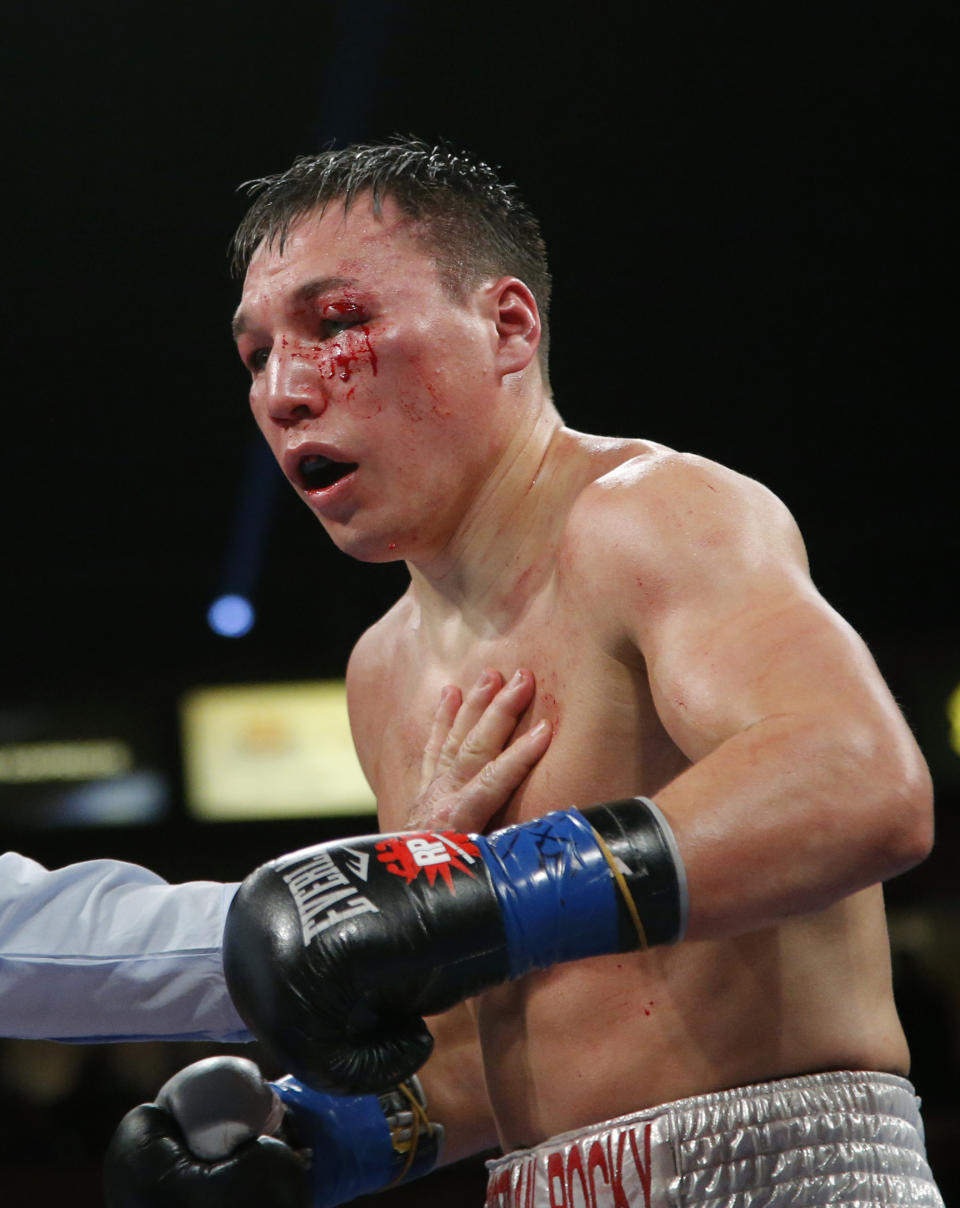 Ruslan Provodnikov, of Russia, bleeds in the ninth round of a WBO welterweight title boxing match against Timothy Bradley in Carson, Calif., Saturday, March 16, 2013. (AP Photo/Jae C. Hong)