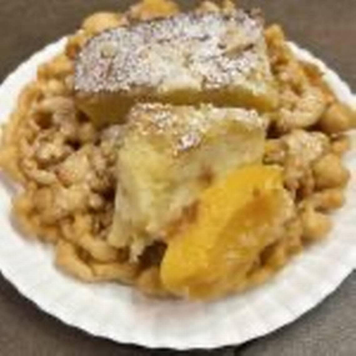 An image of peach cobbler funnel cake.