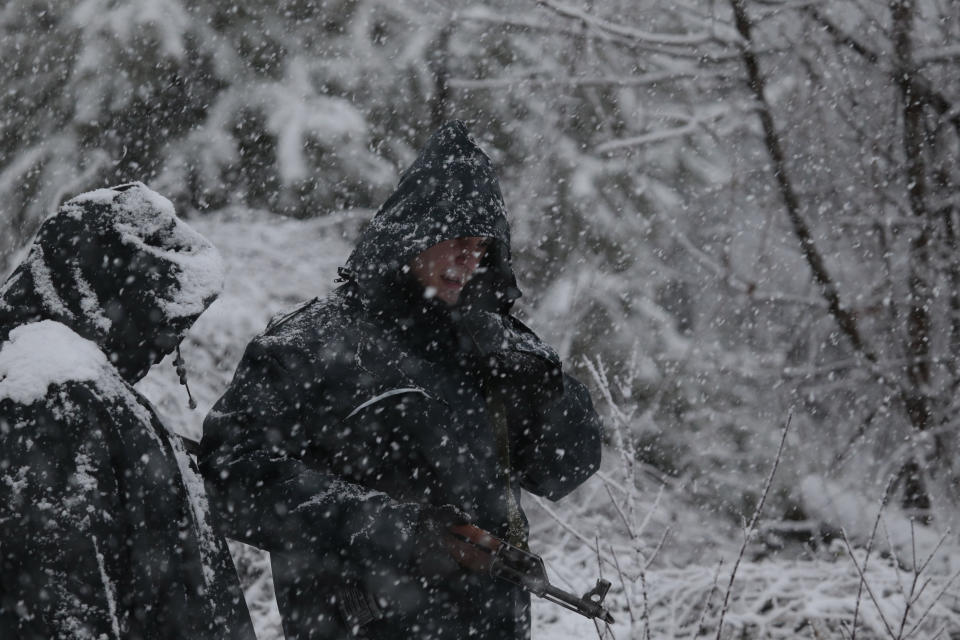 Bosnian police secure an area in Bradina, Bosnia, Monday, Feb. 11, 2019. Police in Bosnia say they have launched a manhunt for a suspect in the killings of two people in the past week which has triggered panic in the country. (AP Photo/Amel Emric)