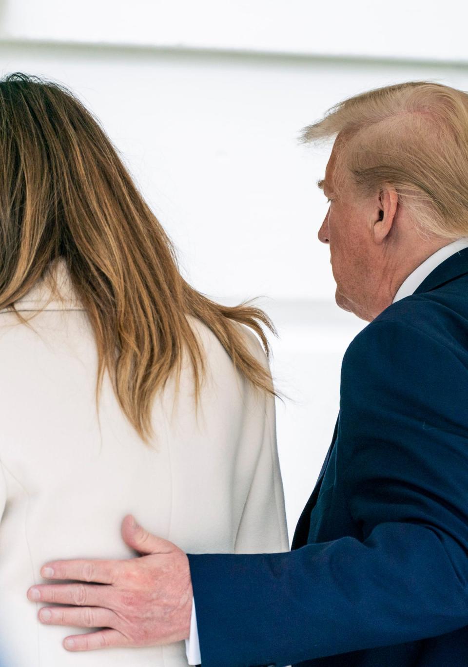Then-US president Donald Trump and first lady Melania Trump arrive to the White House after a trip to Baltimore, Maryland, on 25 May 2020 (Getty)