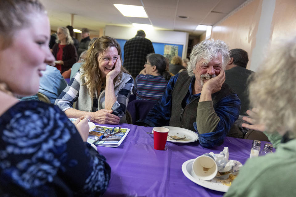 Nancy Davis, left, and Shorty Towne, right, talk with fellow residents during a pot luck luncheon following the annual Town Meeting, Tuesday, March 5, 2024, in Elmore, Vt. After nearly four hours, Town Meeting adjoins and residents of all political background sit down for lunch at the United Methodist church across the street. (AP Photo/David Goldman)