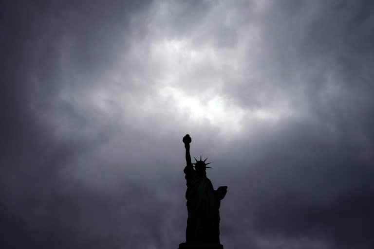 The Statue of Liberty stands tall as clouds hover over New York on October 3, 2015