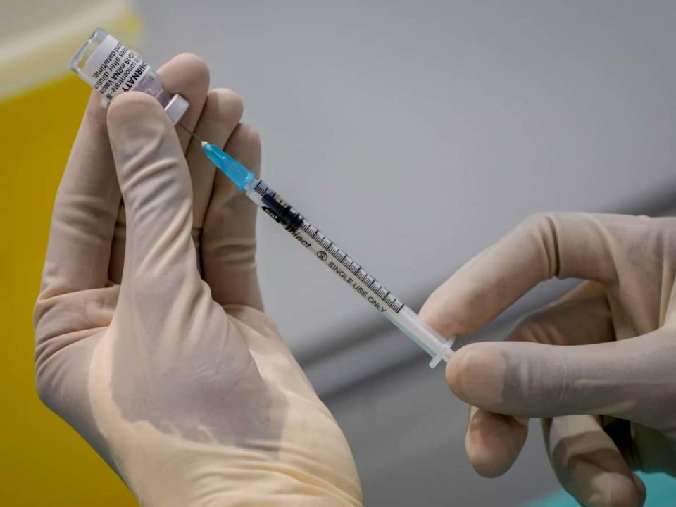 Dentists in Newfoundland and Labrador are willing to help deliver COVID-19 vaccines and boosters.  (Michael Probst/Associated Press - image credit)