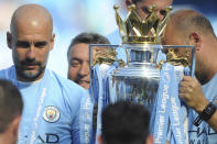 <p>Manchester City manager Josep Guardiola, left, looks at the English Premier League trophy after the soccer match between Manchester City and Huddersfield Town at Etihad stadium in Manchester, England, Sunday, May 6, 2018. (AP Photo/Rui Vieira) </p>