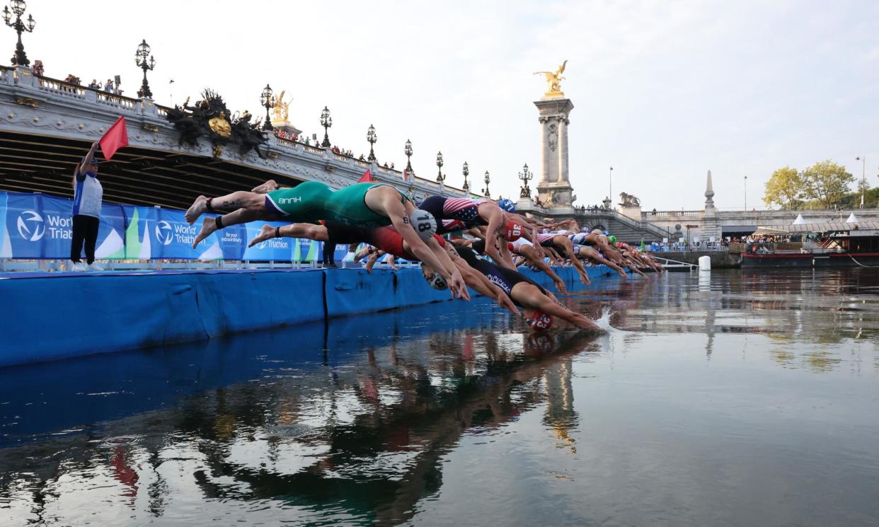 <span>Triathletes dive into the Seine at an Olympic test event in August 2023.</span><span>Photograph: Stéphanie Lecocq/Reuters</span>