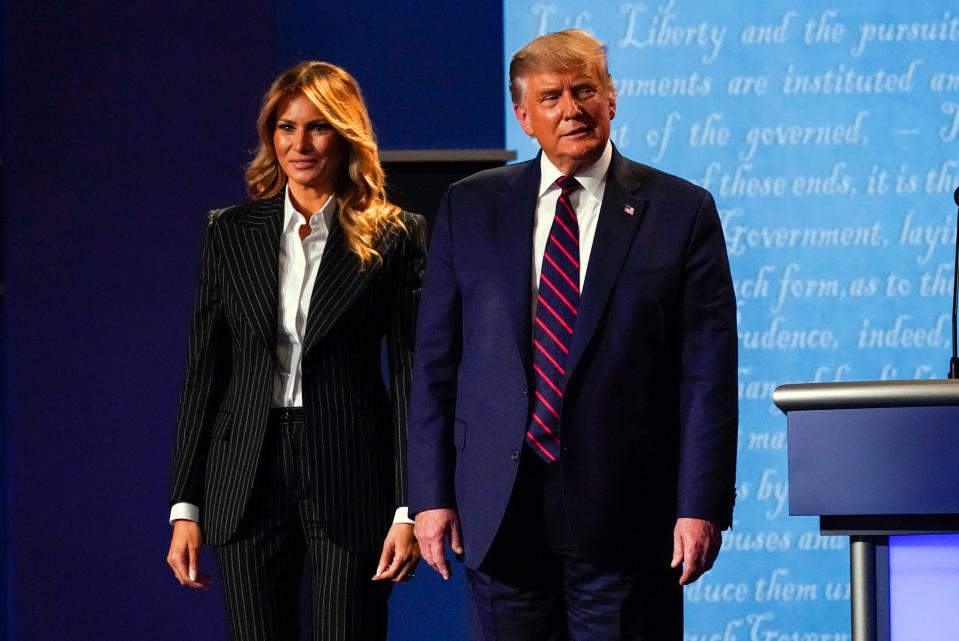 President Donald Trump stands on stage with first lady Melania Trump after the first presidential debate with Democratic presidential candidate Joe Biden.