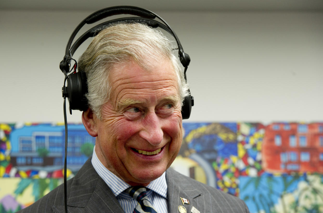 Britain's Prince Charles wears headphones as he learns how to scratch and fade with a turntable while he tours an employment skills workshop in Toronto on May 22, 2012. The royal couple is on a four-day visit to Canada to mark the Queen's Diamond Jubilee.      AFP PHOTO/Paul Chiasson/Pool        (Photo credit should read PAUL CHIASSON/AFP/GettyImages)