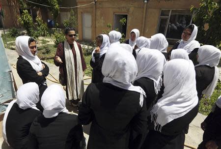 Hassina Sherjan, director of Aid Afghanistan for Education (AAE), talks with students at a school in Kabul May 13, 2014. REUTERS/Omar Sobhani