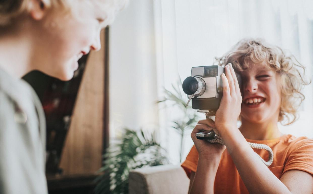 young boy with vintage video camera