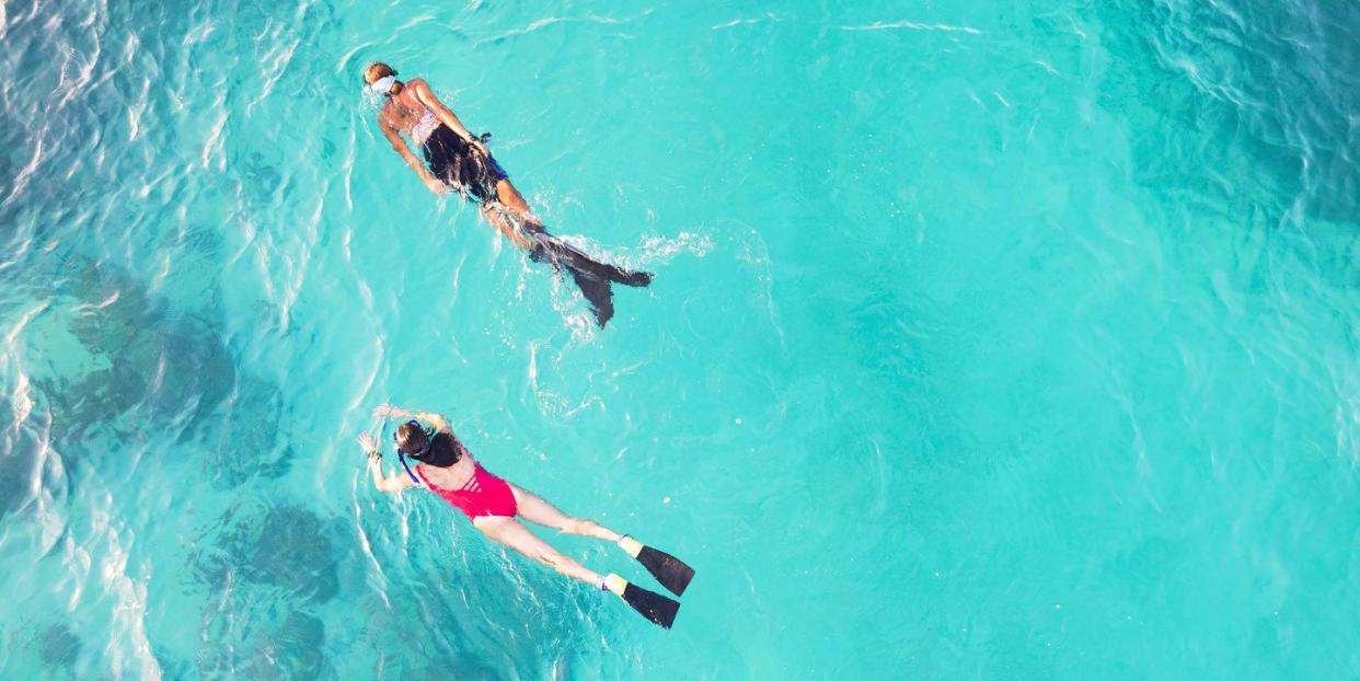 aerial view of two women snorkeling in the ocean