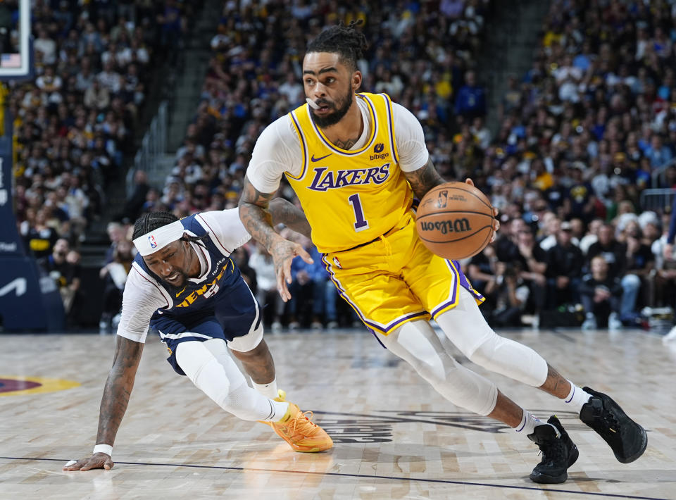 Los Angeles Lakers guard D'Angelo Russell (1) drives past Denver Nuggets guard Kentavious Caldwell-Pope in the second half of Game 5 of an NBA basketball first-round playoff series Monday, April 29, 2024, in Denver. (AP Photo/David Zalubowski)