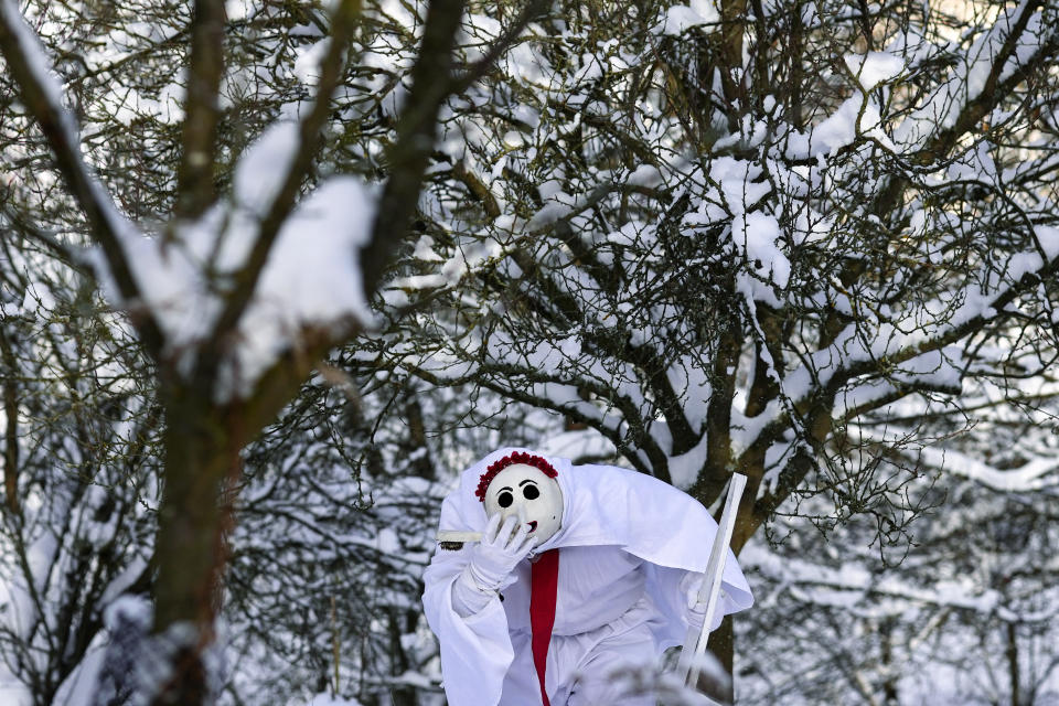 A reveler depicting death takes part in a traditional St Nicholas procession in the village of Lidecko, Czech Republic, Monday, Dec. 4, 2023. This pre-Christmas tradition has survived for centuries in a few villages in the eastern part of the country. (AP Photo/Petr David Josek)