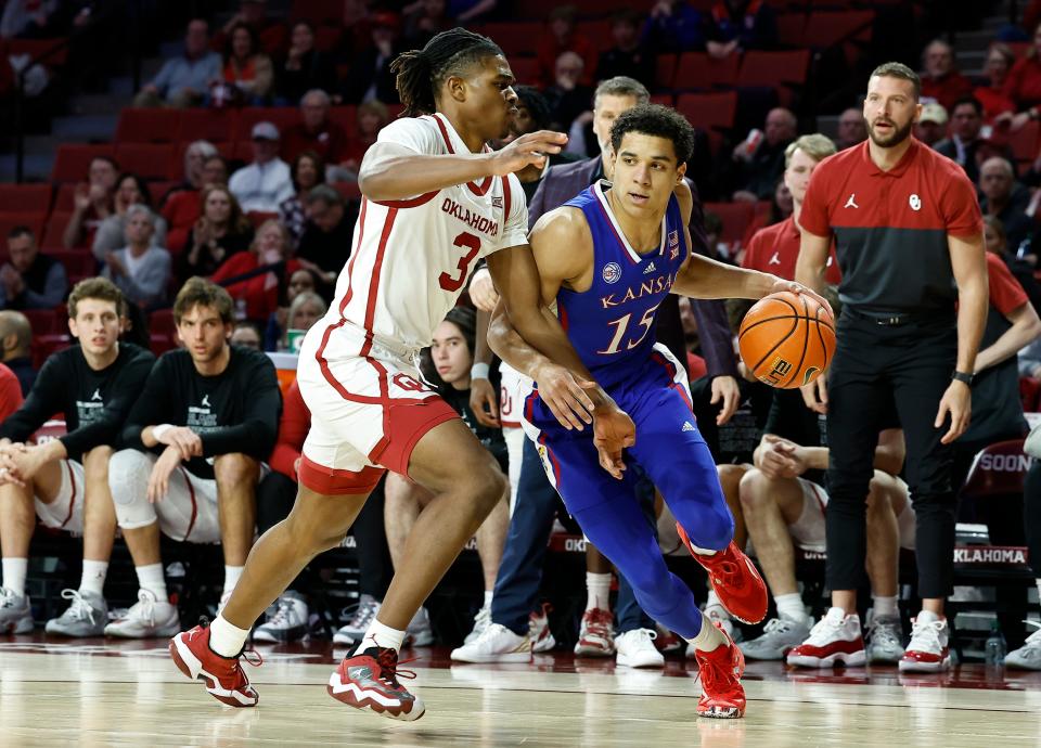 Kansas guard Kevin McCullar Jr. (15) drives around Oklahoma guard Otega Oweh (3) during the first half of their 2023 game at Lloyd Noble Center.