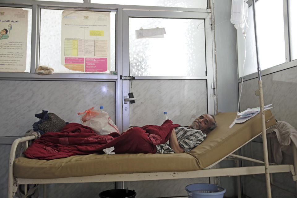 FILE - In this Thursday, March 28, 2019 file photo, a man is treated for suspected cholera infection at a hospital in Sanaa, Yemen. Cholera is surging once more in Yemen, with more than 76,000 suspected new cases and 195 deaths in March, double the number in the previous two months, according to U.N. figures. Doctors point to the difficulty in controlling epidemics in a country where infrastructure has been decimated by four years of war. (AP Photo/Hani Mohammed, File)