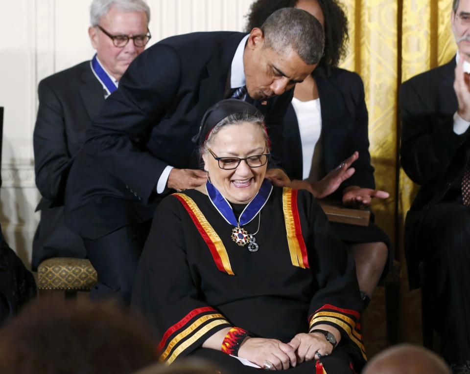 U.S. President Barack Obama presents the Presidential Medal of Freedom to Native American writer, curator, and activist Suzan Harjo during a White House ceremony in Washington, November 24, 2014. (REUTERS/Larry Downing)