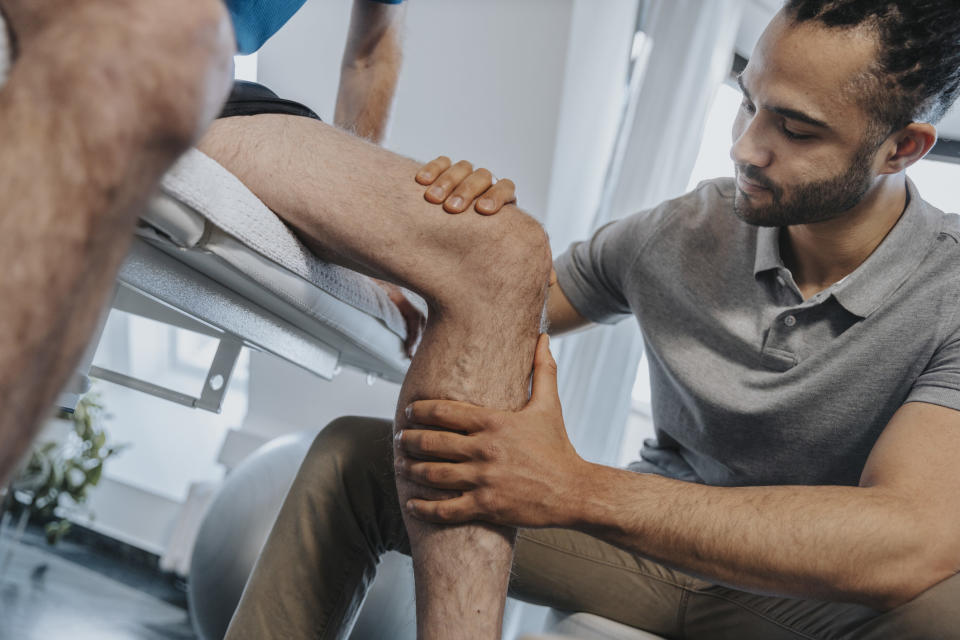 a physical therapist helping someone