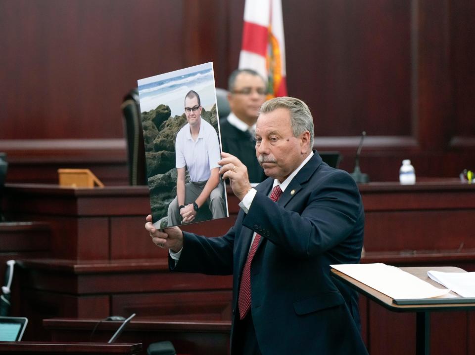 State Attorney R. J. Larizza shows a picture of Jason Raynor to the jury during the Othal Wallace murder trial in Clay County, Monday, Sept. 11, 2023. 