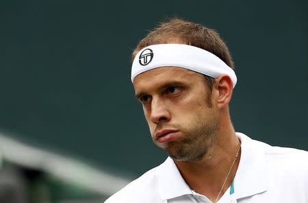 Gilles Muller of Luxembourg reacts as he plays Switzerland's Stan Wawrinka during their semi-final men's singles tennis match at the Japan Open championships in Tokyo October 10, 2015. REUTERS/Thomas Peter