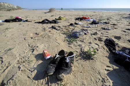 Clothes belonging to migrants lie on the beach of Siculiana, in Western Sicily, Italy February 19, 2016. REUTERS/Guglielmo Mangiapane