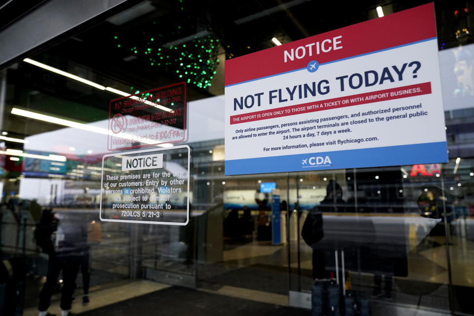 Information signs are seen Terminal 3 at O'Hare International Airport in Chicago, Thursday, Dec. 22, 2022. Frigid air is moving through the central United States to the east, with windchill advisories affecting about 135 million people over the coming days, weather service meteorologist Ashton Robinson Cook said Thursday. (AP Photo/Nam Y. Huh)