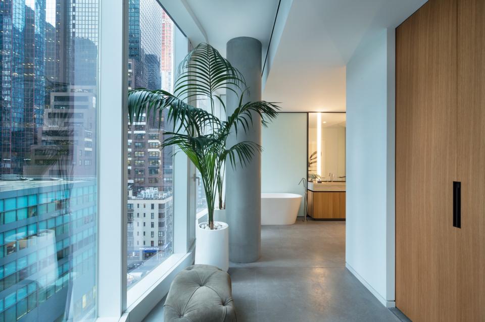 A bathroom at the back of one of the loft units. Rosen consciously planned for the lofts to be on the building's lower levels, all the better to interact with the city. "You see people walking below on Park Avenue; you're really in the bustle," he says. "We played that energy up rather than down." Further underscoring this is a departure from the near hermetic sealing of most new apartments; the loft's massive windows open, a rarity for New York. "In the summer, I need fresh air," Rosen says.