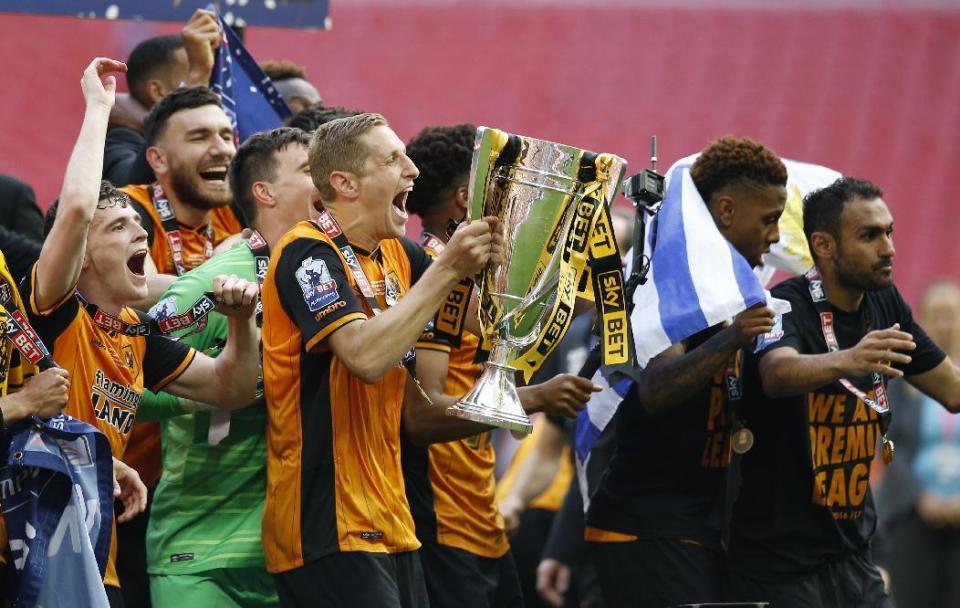 Britain Soccer Football - Hull City v Sheffield Wednesday - Sky Bet Football League Championship Play-Off Final - Wembley Stadium - 28/5/16 Hull City's Michael Dawson lifts the trophy as they celebrate winning promotion back to the Premier League Action Images via Reuters / Andrew Couldridge Livepic EDITORIAL USE ONLY. No use with unauthorized audio, video, data, fixture lists, club/league logos or "live" services. Online in-match use limited to 45 images, no video emulation. No use in betting, games or single club/league/player publications. Please contact your account representative for further details.