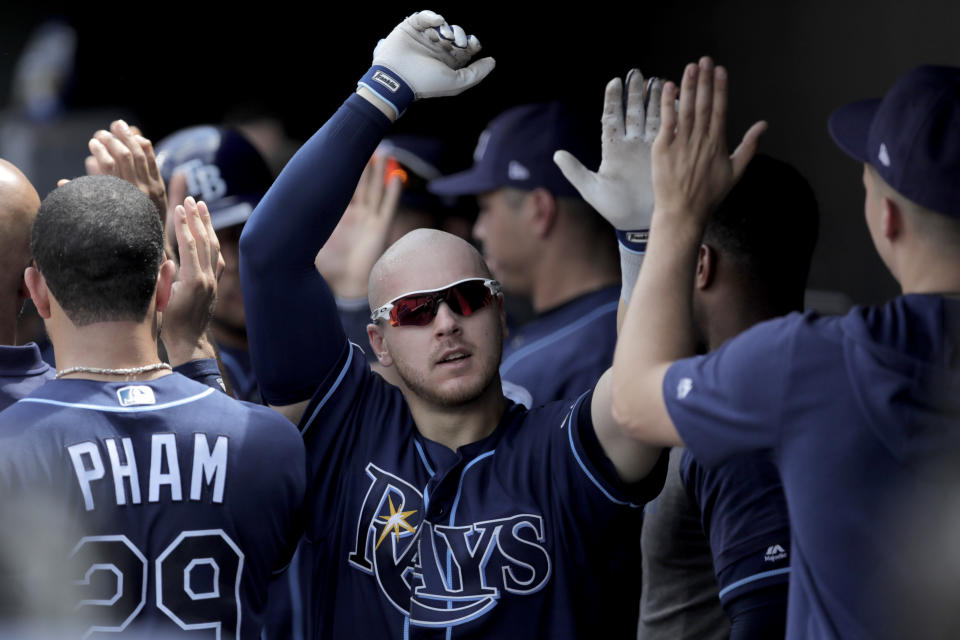 Tampa Bay Rays' Michael Brosseau is greeted in the dugout after hitting a two-run home run off Baltimore Orioles starting pitcher Thomas Eshelman during the sixth inning of a baseball game, Sunday, July 14, 2019, in Baltimore. (AP Photo/Julio Cortez)