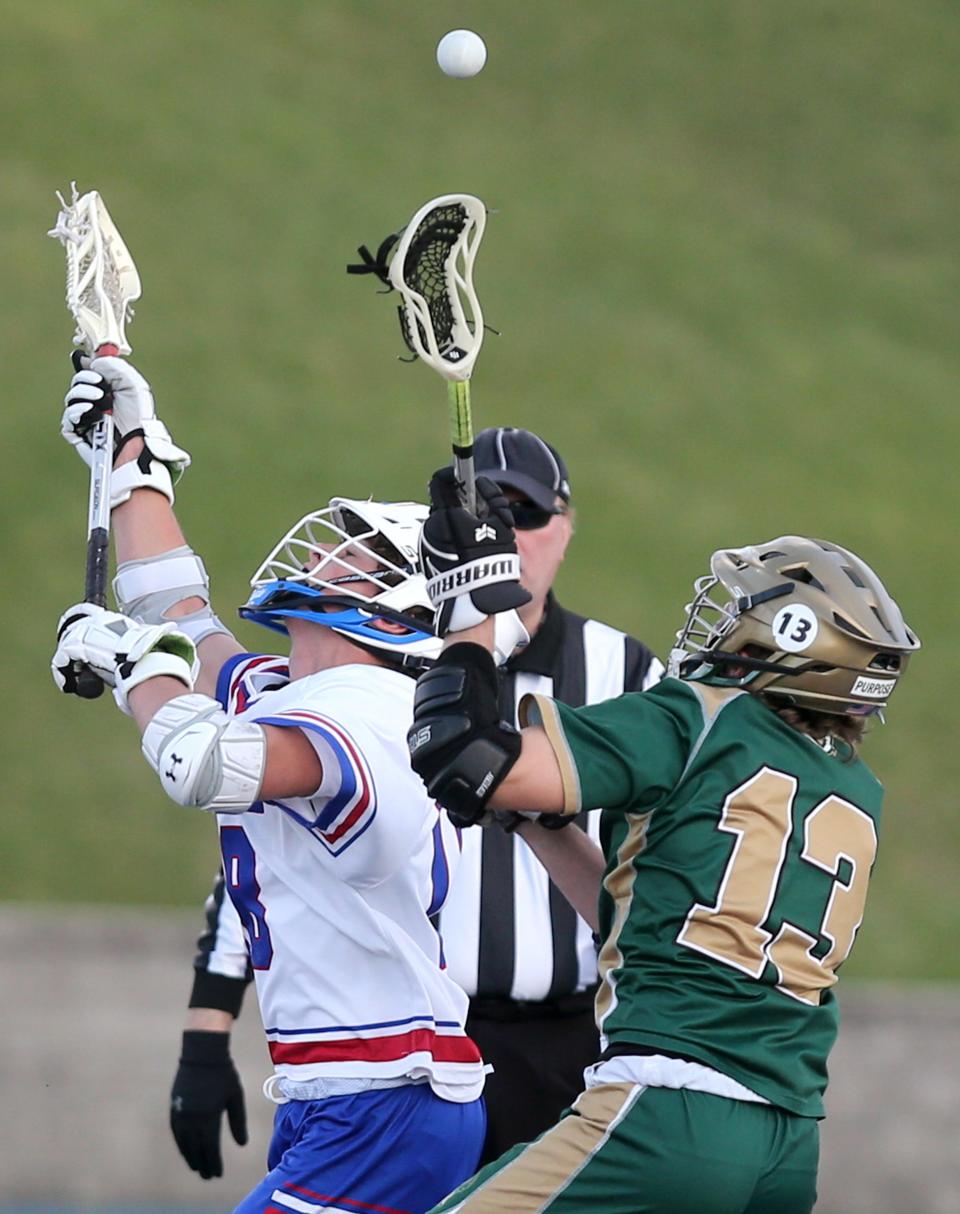 Max Gullace, left, of Lake fights for the ball with Logan Kinzler, 13, of GlenOak during their game at Lake on Thursday, April 14, 2022. 