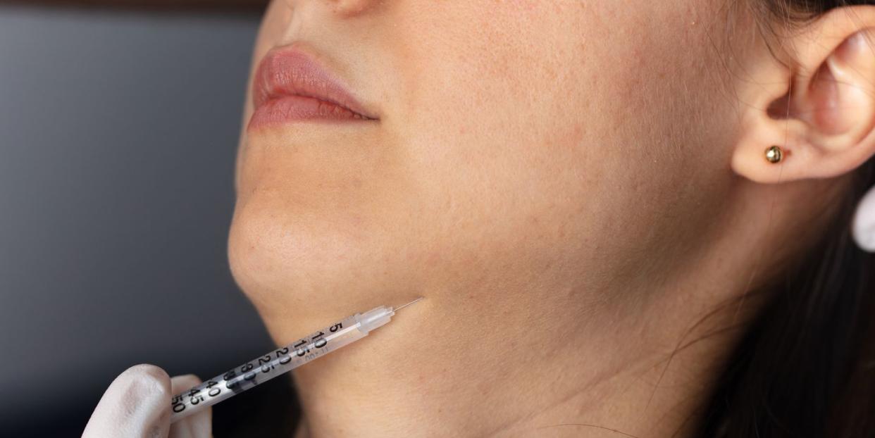injection to the face in the chin area aesthetics, medicine concept youth injections