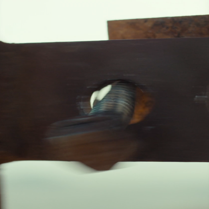 A loose bolt pops out of a rusty ladder