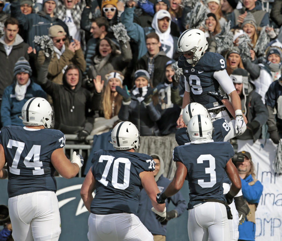 Penn State quarterback Trace McSorley is lifted in the air by teammate Mike Gesicki after scoring a touchdown against Rutgers. (AP Photo)